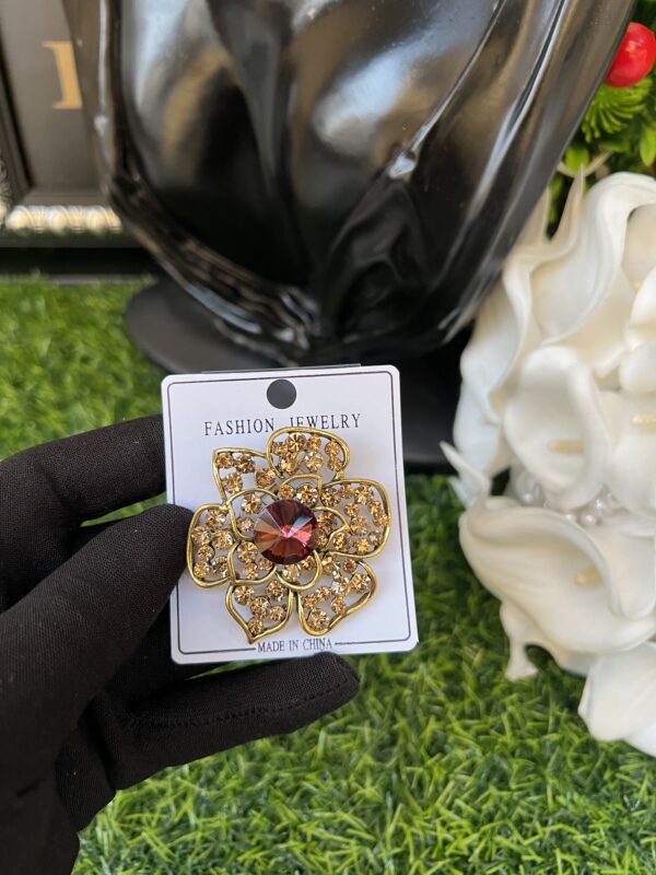 Gold colored brooch