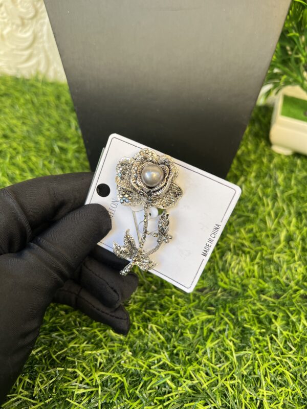Grey stoned flower brooch