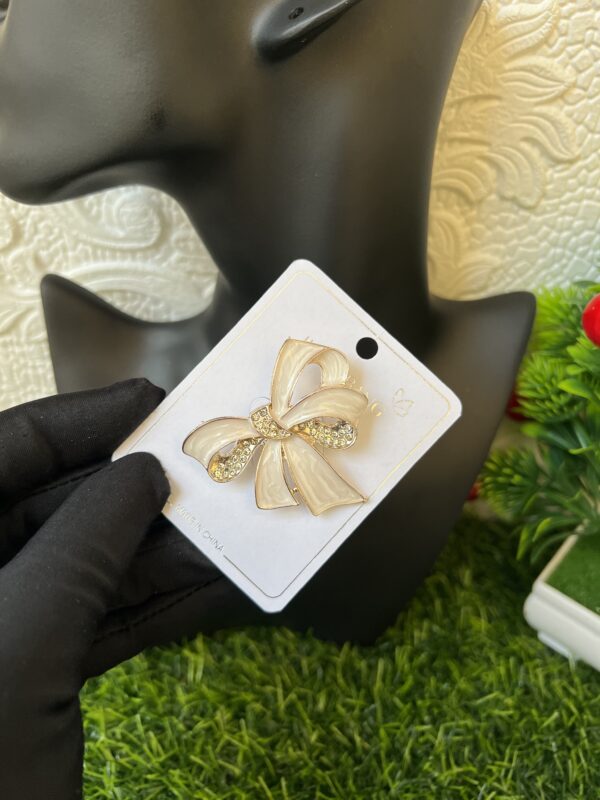 White bow tie brooch
