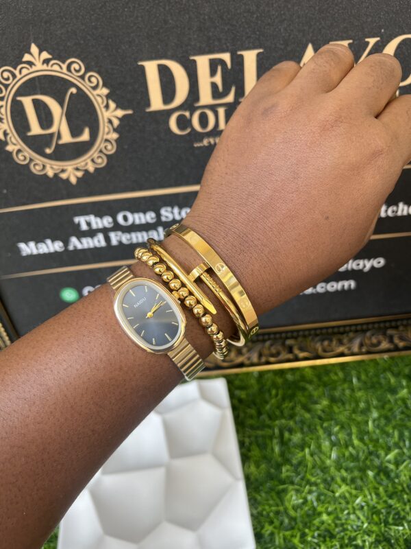 Sleek gold watch and bracelet stack