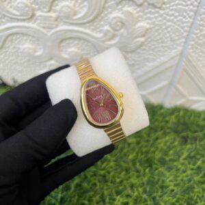 gogory gold watch with red face