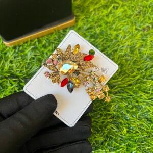 Precious colored brooch